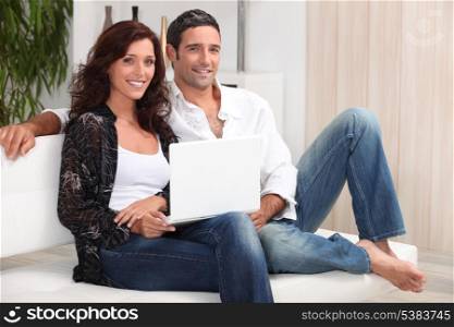 a 35 years old couple sitting on a couch