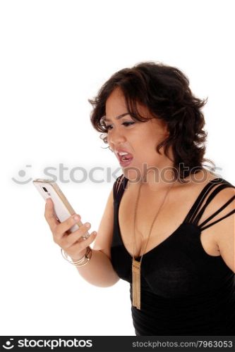 A angry young mixed raced woman holding her cell phone and shoutingat it, isolated for white background.