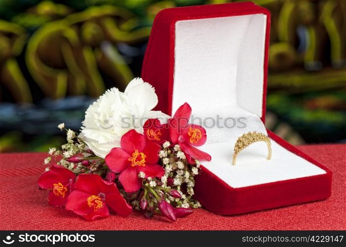 a Arrangement with flowers and wedding rings