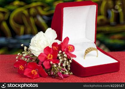 a Arrangement with flowers and wedding rings