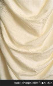 A background image of the flowing fabric of a wedding dress.