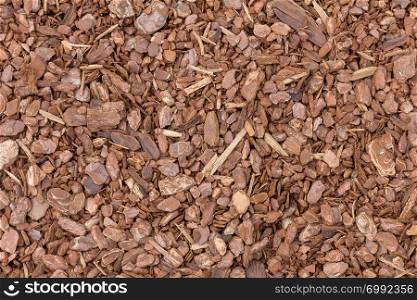 A background image of wood chip used for safety in toddlers playgrounds