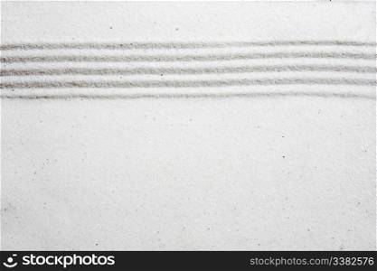 A background image with white sand and a raked stripe