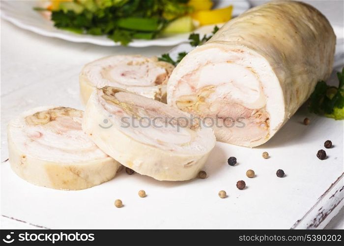 A baked chicken roll on the white cutting board