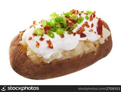 A baked potato loaded with sour cream, bacon bits, and chives. Shot on white background.