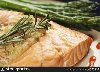 A baked stuffed salmon with asparagus on the side