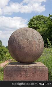 A ball made of stone on a pedestal