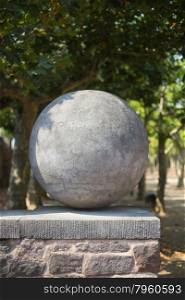 A ball made of stone on a wall