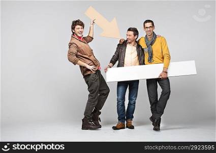 A band of male young friends with signs