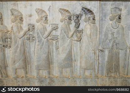 A bas-relief depiction of Lydian embassy tribute bearers carry present for the king at Apadana, East Stairs, southern part of Persepolis. Fars Province, Shiraz, Iran.