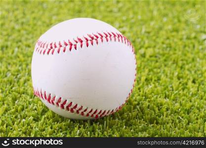 A baseball over a green grass field
