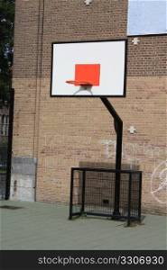 A basket ball board on a school yard playground