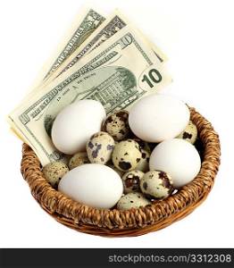 A basket containing money and all kinds of different eggs - hens, quails and artificial - over a white background. Financial or business concept for saving, investment or financial management