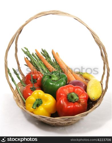 A basket of colorful harvest fresh vegetables. White background.