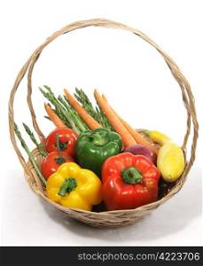 A basket of colorful harvest fresh vegetables. White background.