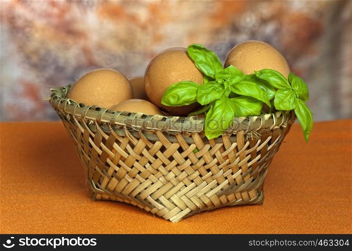 A basket of fresh eggs with orange background