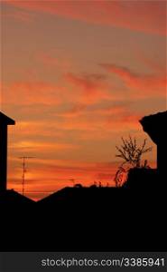 A Beatiful sunset over silhouettes of houses