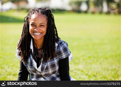 A beautiful African American woman isolated on grass
