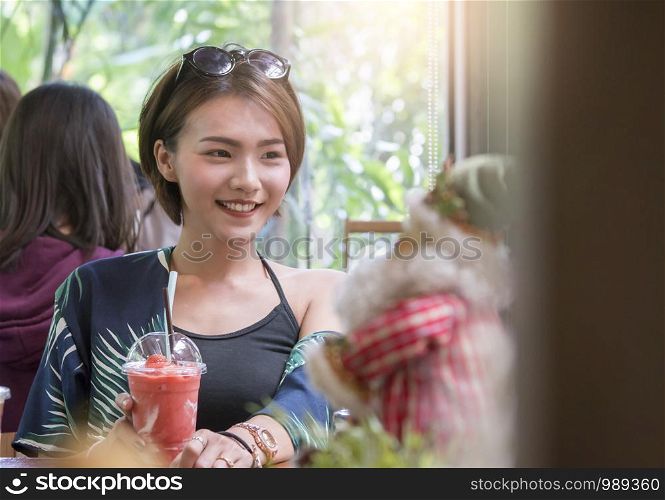 A beautiful asian woman sitting and relaxing in cafe