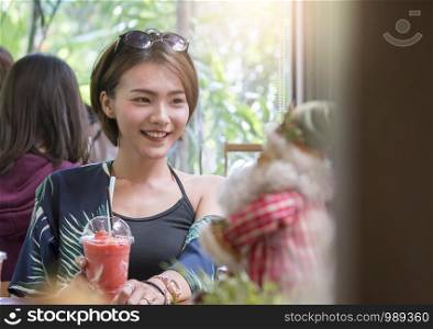 A beautiful asian woman sitting and relaxing in cafe