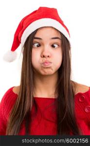 A beautiful asian woman with a christmas hat making a silly expression