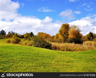 a beautiful autumn landscape with a blue cloudy sky
