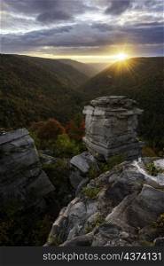 A beautiful Autumn sunset from Lindy Point in Blackwater Falls State Park as the setting sun casts its warm light down into the Blackwater Canyon, illuminating its foliage and ridges.