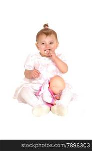 A beautiful baby in a pink dress sitting on the floor, eating a biscuits, isolatedfor white background.