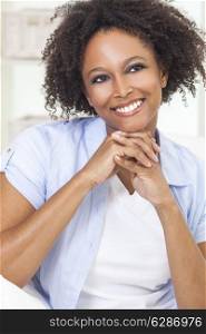 A beautiful black mixed race African American girl or young woman looking happy and smiling
