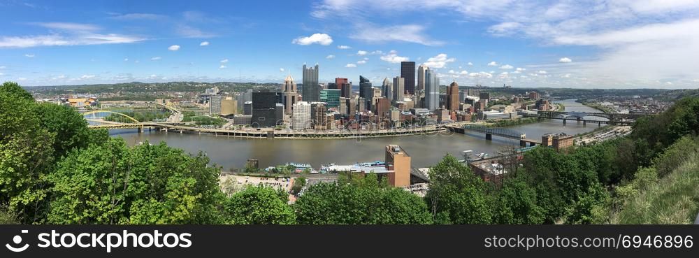 A beautiful blue sky clear day over the downtown city skyline in Pittsburgh PA