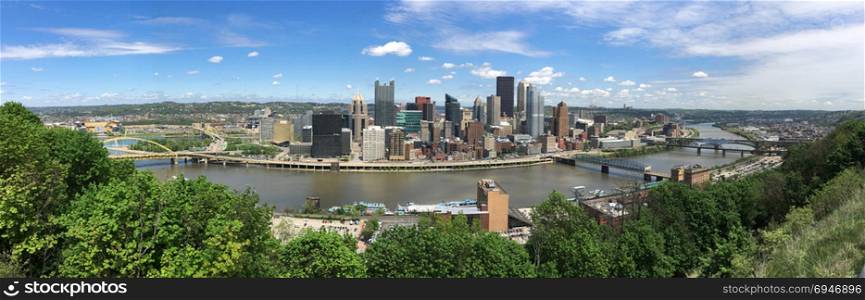 A beautiful blue sky clear day over the downtown city skyline in Pittsburgh PA