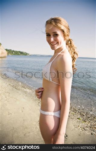 A beautiful caucasian girl outdoor on the beach during summer