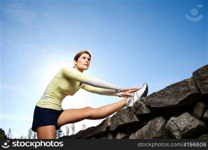 A beautiful caucasian woman doing exercise outdoor in a park