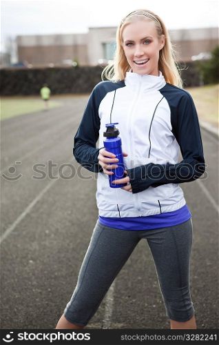 A beautiful caucasian woman exercises in a sport field