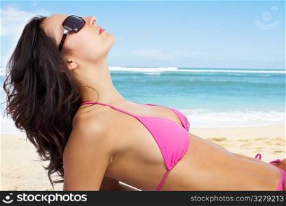 A beautiful caucasian woman lying down on the beach