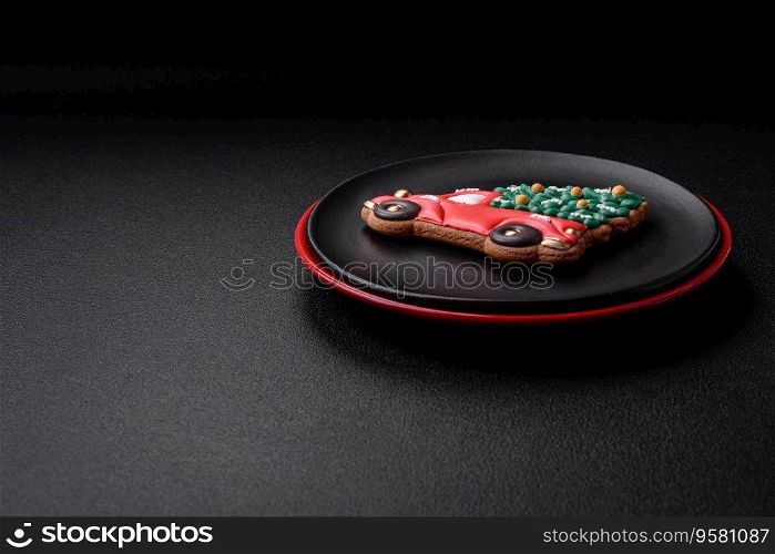 A beautiful Christmas composition consisting of ceramic plates, gingerbread and other elements of New Year’s decorations on a dark concrete background