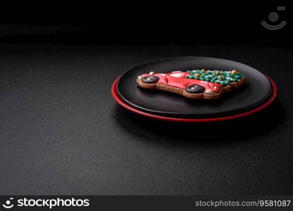 A beautiful Christmas composition consisting of ceramic plates, gingerbread and other elements of New Year’s decorations on a dark concrete background