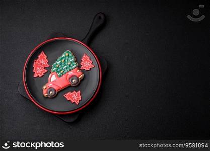 A beautiful Christmas composition consisting of ceramic plates, gingerbread and other elements of New Year&rsquo;s decorations on a dark concrete background
