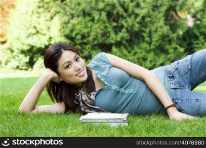 A beautiful college student relaxing at a park