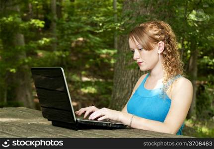 A beautiful computer savvy young woman using a laptop