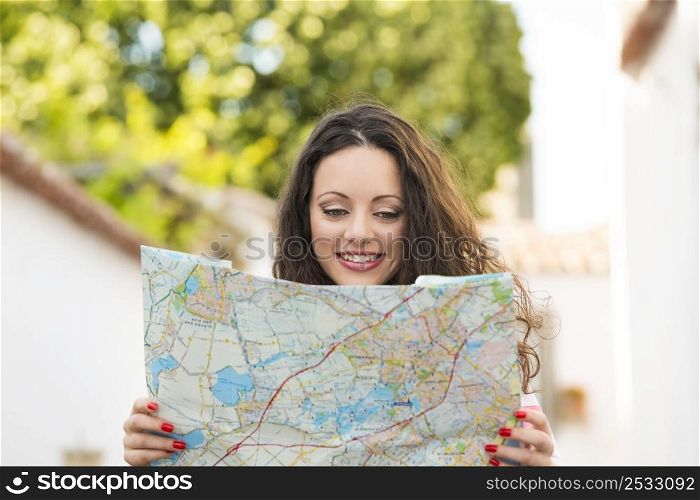 A beautiful female tourist searching a place on the map