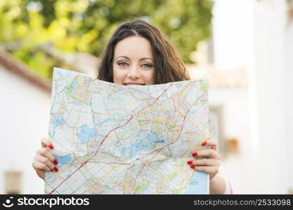 A beautiful female tourist searching a place on the map