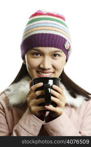 A beautiful girl holding a cup of hot drink