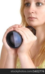 A beautiful girl with blond hair holding a photo lens in her hand, with aserious look, in closeup over white background.