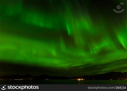 A beautiful green Aurora borealis or northern lights at Tromso, Norway