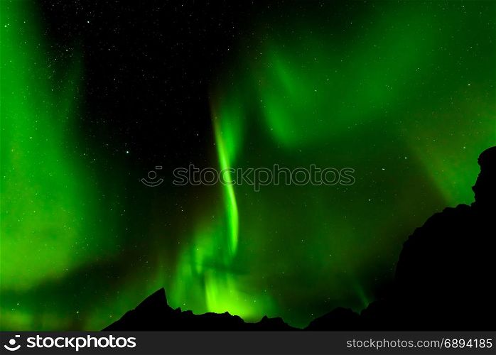 A beautiful green Aurora borealis or northern lights, Norway, selective focus