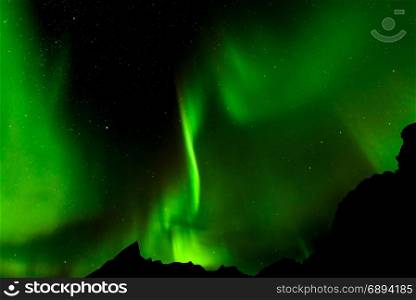 A beautiful green Aurora borealis or northern lights, Norway, selective focus