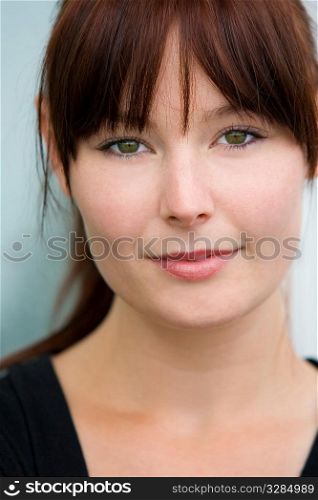 A beautiful green eyed woman looks enigmatically into the lens
