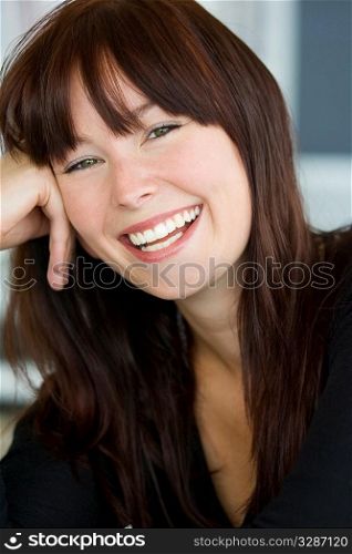 A beautiful green eyed young woman relaxed and laughing