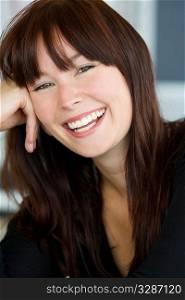 A beautiful green eyed young woman relaxed and laughing